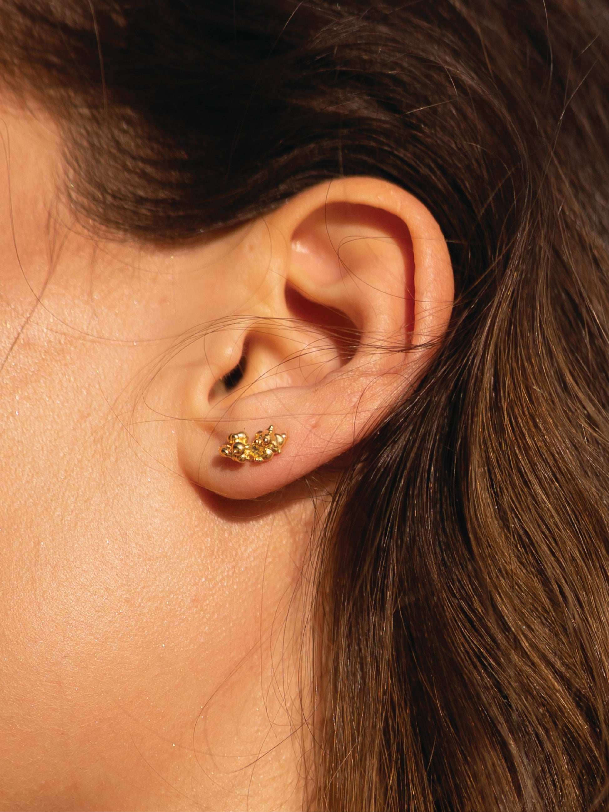 Close-up of an ear with a gold earring