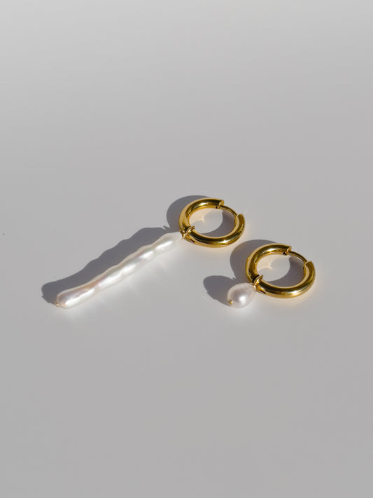Biwa Pearl Gold Hoops. Chunky 18 karat Gold filled hoops, suspends both elongated Biwa, and round, natural AAA quality freshwater pearls, in a minimal asymmetrical design. Designed and made by nāmaka