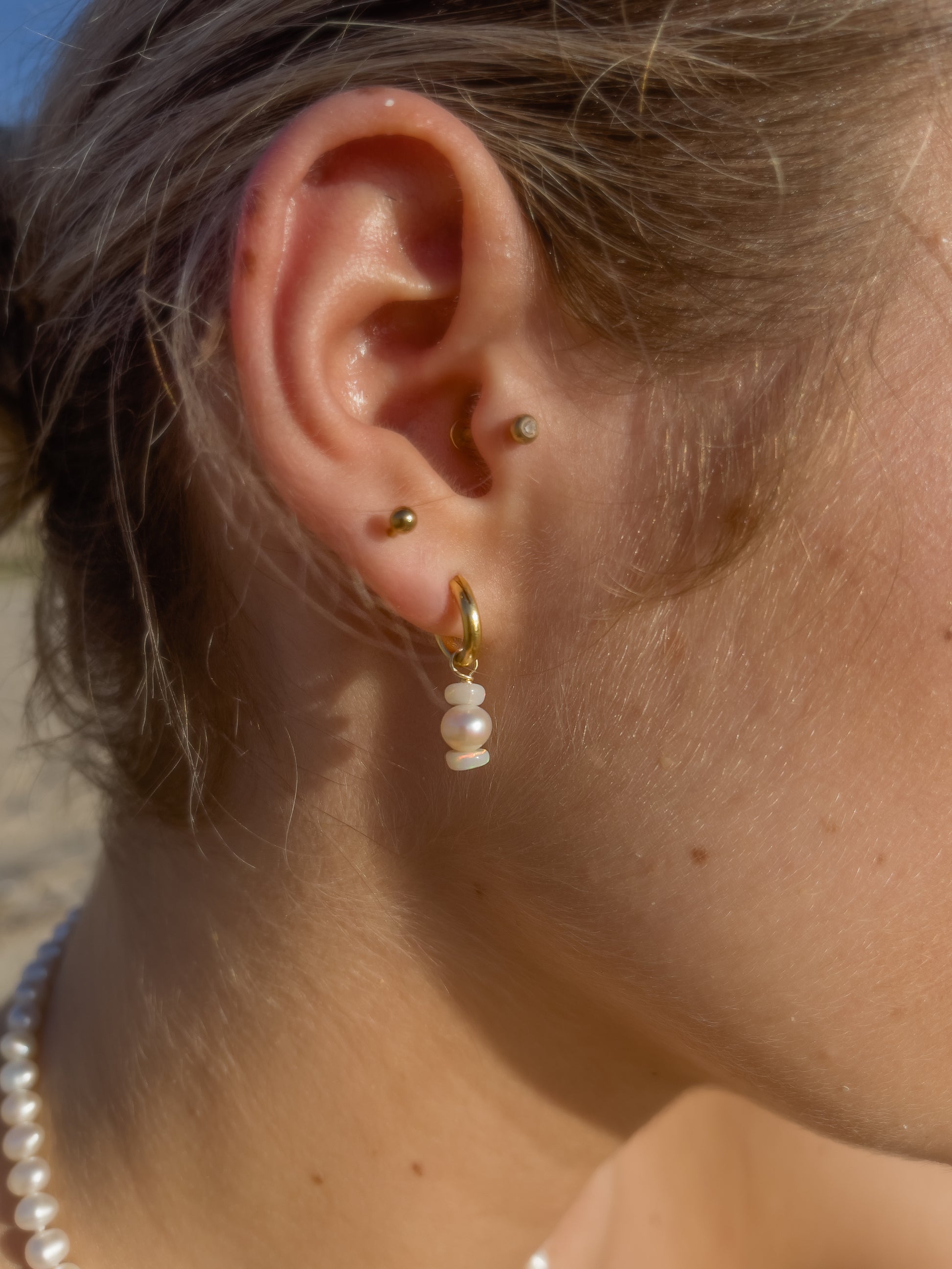 Mini Confetti Opal & Pearl Gold Hoops. Tiny 14 karat Gold filled Sterling Silver sleeper hoops, suspend clusters of natural freshwater pearls, and Australian Opals, in a minimal asymmetrical design.