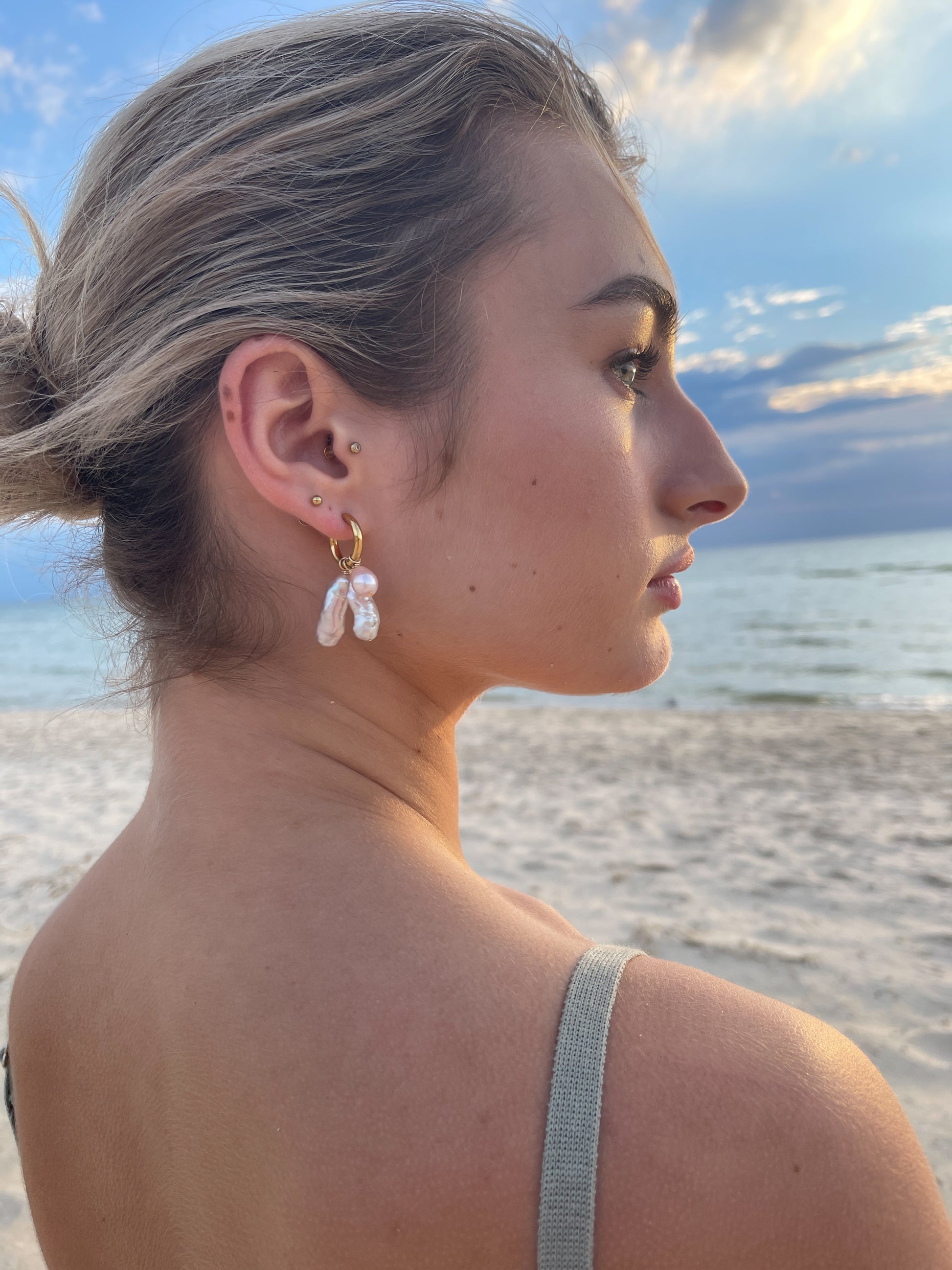 Violet Keshi Pearl Hoop Earrings. Chunky 18 karat Gold filled hoops, suspends both Violet Keshi, and Violet Teardrop pearls, and are AA quality.  In this minimal design, the free formed Keshi pearls, against the ultra smooth teardrop pearls are strikingly unique.