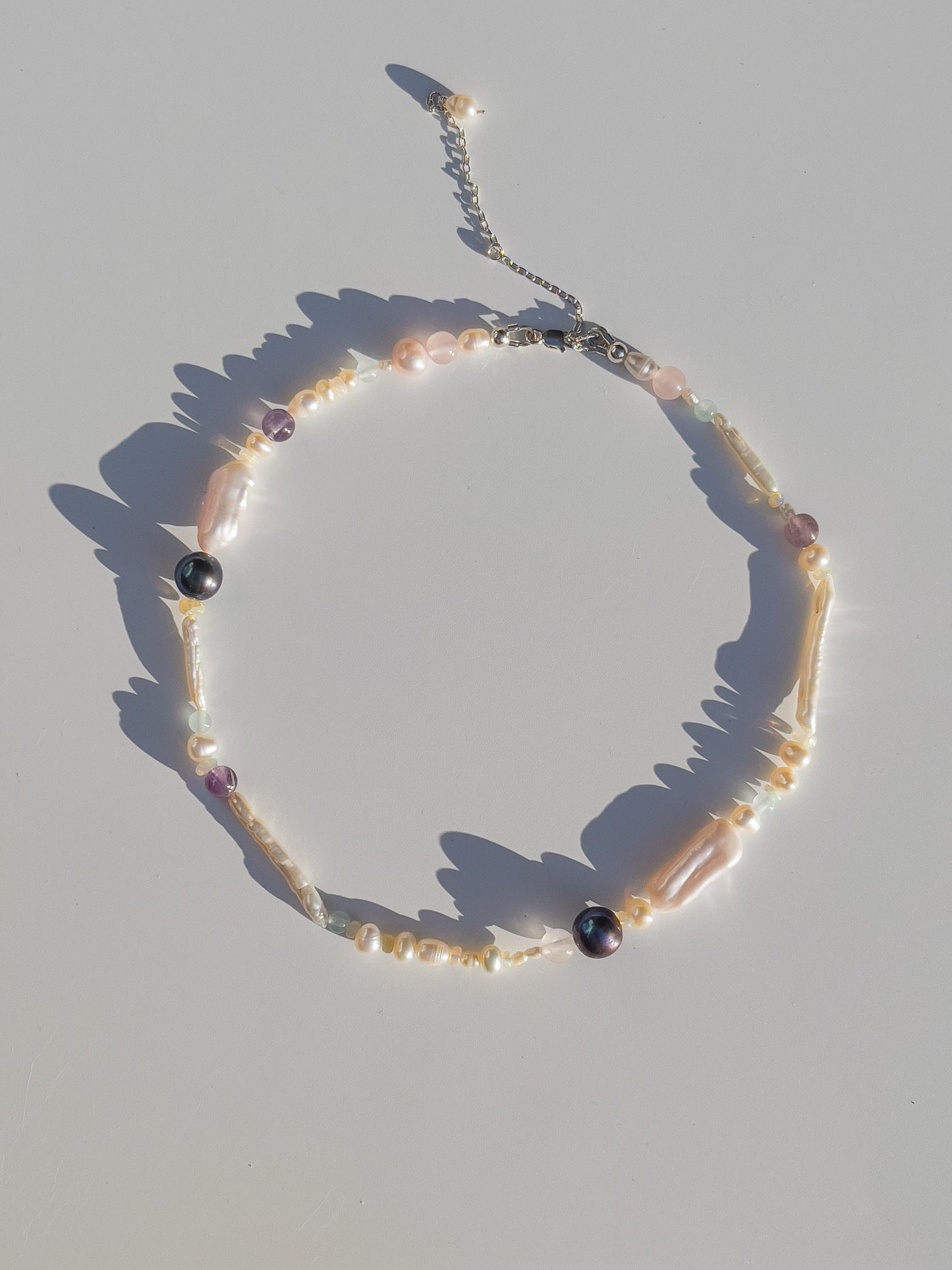 Tahitian Black Pearl & Opal Multi-Stone Choker Necklace - Glistening in candy colours, and finished with Sterling Silver hardware, this necklace is absolutely gorgeous. Hand crafted with a variety of Vibrant White Keshi Pearls, Estate re-purposed Tahitian Black Pearls, Biwa Pearls, Freshwater Pearls & Pink Freshwater Pearls. Combined with a glittery cluster of Australian Opals, Aquamarine, Blue Lace Agate, Jade, and the ultimate - The Super Seven Stone. Designed and personally handcrafted by Nāmaka