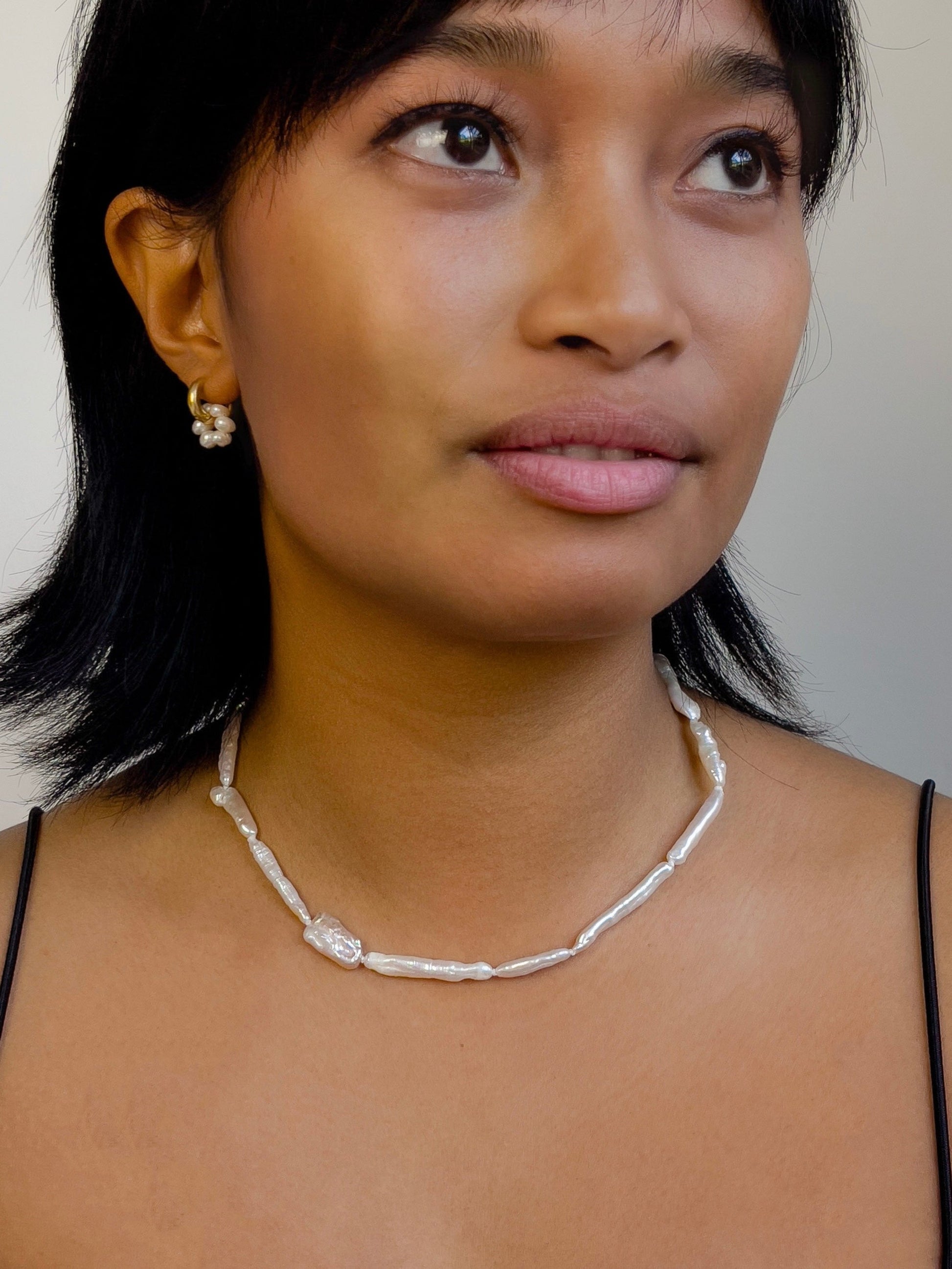 Luxe Keshi & Biwa Pearl Necklace. Biwa and Keshi pearls, naturally white with an iridescent shine and in free formed shapes feature on this stunning necklace. Elongated shaped Biwa pearls are peppered with nugget shaped Keshi pearls. This necklace is handcrafted using 100% Silk thread, and is highlighted with 14kt Gold Filled beads and hardware