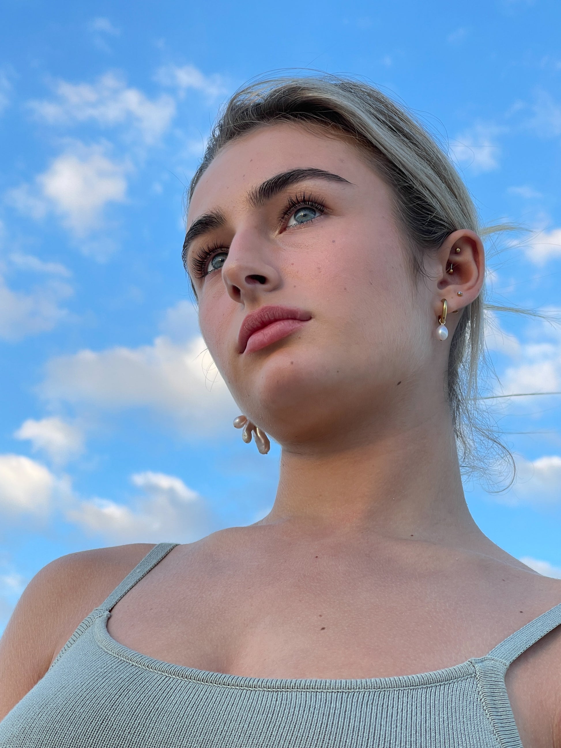 Violet Keshi Pearl Hoop Earrings. Chunky 18 karat Gold filled hoops, suspends both Violet Keshi, and Violet Teardrop pearls, and are AA quality.  In this minimal design, the free formed Keshi pearls, against the ultra smooth teardrop pearls are strikingly unique.