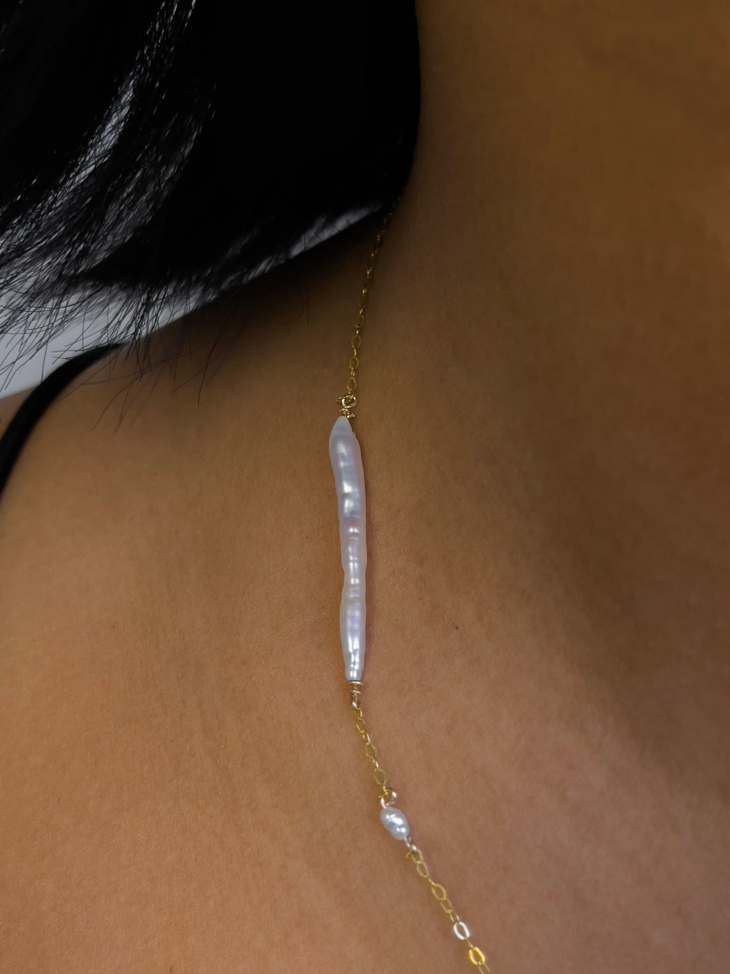 Biwa pearl gold necklace. This ultra fine 14 karat Gold filled with sterling silver flat cable chain suspends gorgeous Biwa elongated freshwater pearls and freshwater seed pearls. Designed and made by nāmaka.