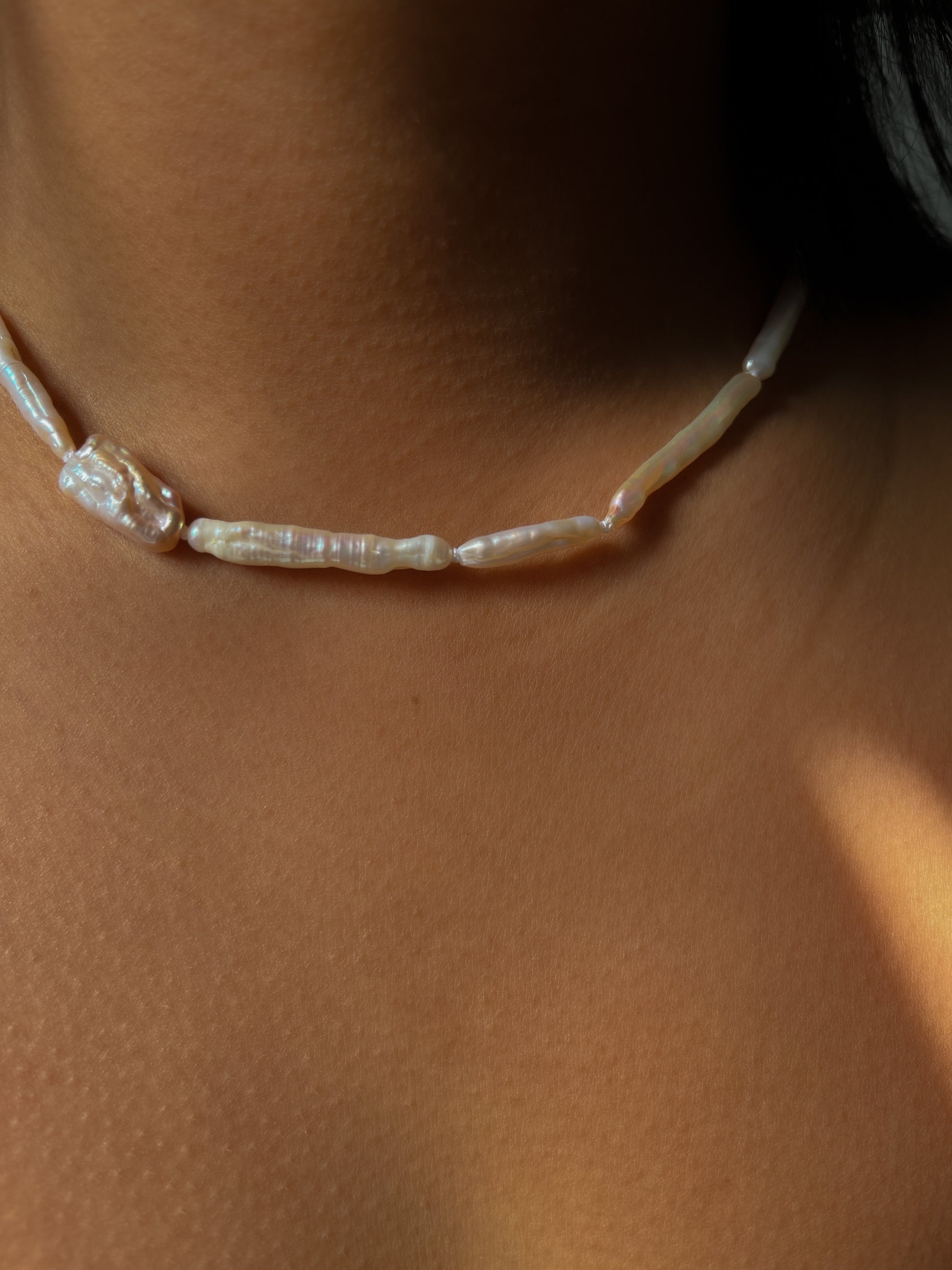 Luxe Keshi & Biwa Pearl Necklace. Biwa and Keshi pearls, naturally white with an iridescent shine and in free formed shapes feature on this stunning necklace. Elongated shaped Biwa pearls are peppered with nugget shaped Keshi pearls. This necklace is handcrafted using 100% Silk thread, and is highlighted with 14kt Gold Filled beads and hardware