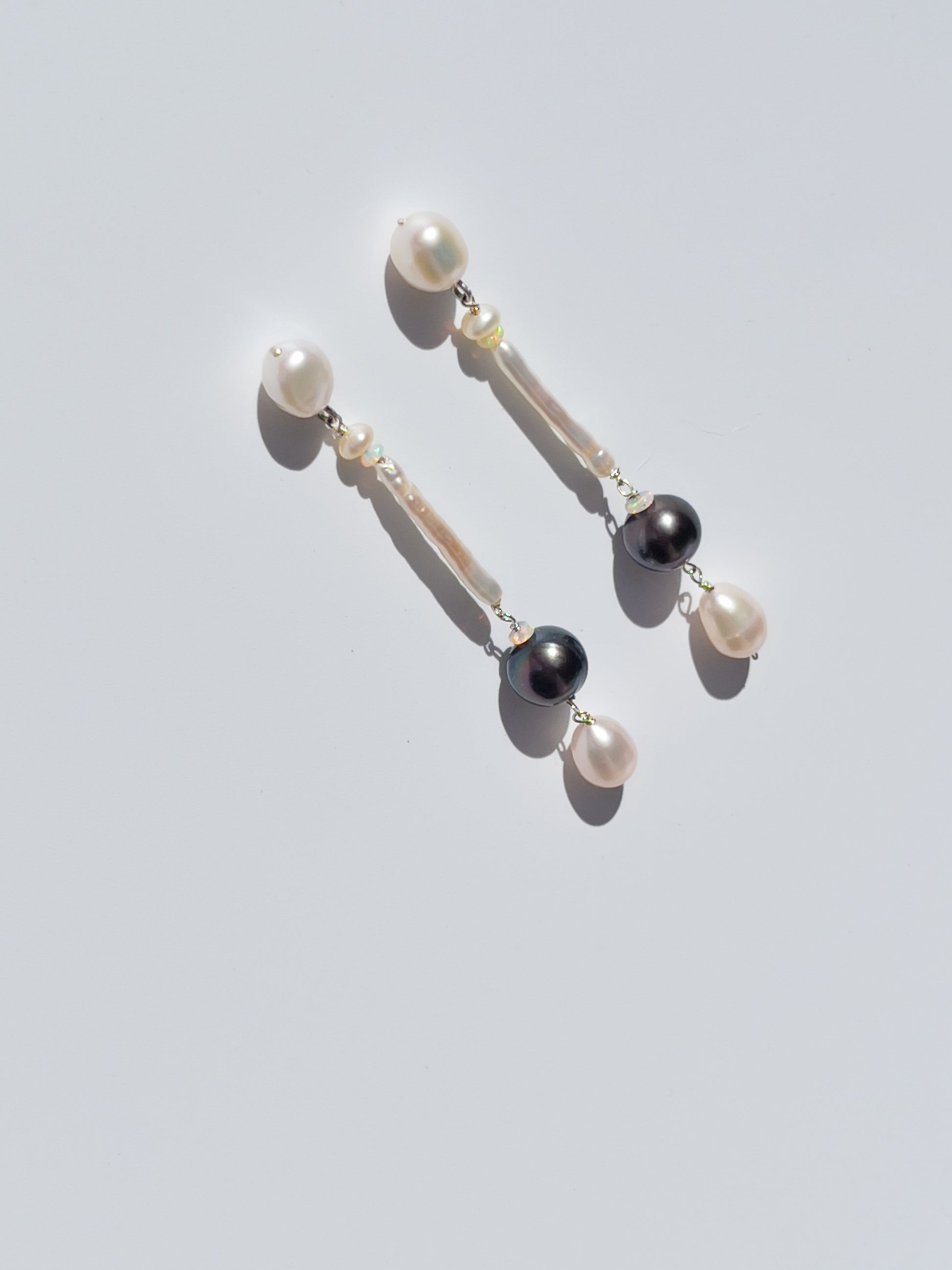 Nāmaka Tahitian Black Pearl & Opal Drop Earrings - These earrings are an absolute showstopper. Hand crafted using Sterling Silver, which suspend a combination of Estate Repurposed Tahitian Black Pearls, Opals, Biwa Pearls, Freshwater Pearls. Finished with Estate Repurposed Violet teardrop AAA pearls. These Nāmaka earrings glisten in candy colours, and are uniquely gorgeous in every way.  Designed & personally handcrafted by Nāmaka in Melbourne Australia