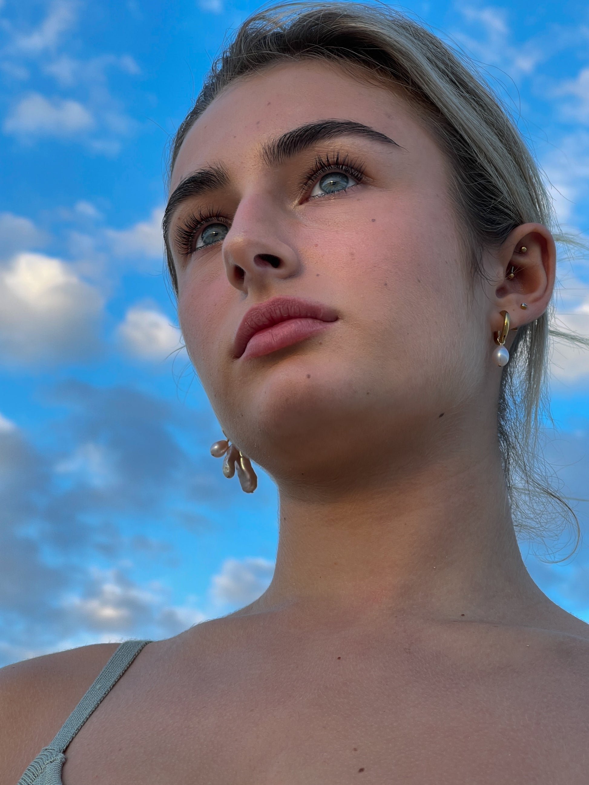 Violet Keshi Pearl Hoop Earrings. Chunky 18 karat Gold filled hoops, suspends both Violet Keshi, and Violet Teardrop pearls, and are AA quality.  In this minimal design, the free formed Keshi pearls, against the ultra smooth teardrop pearls are strikingly unique.