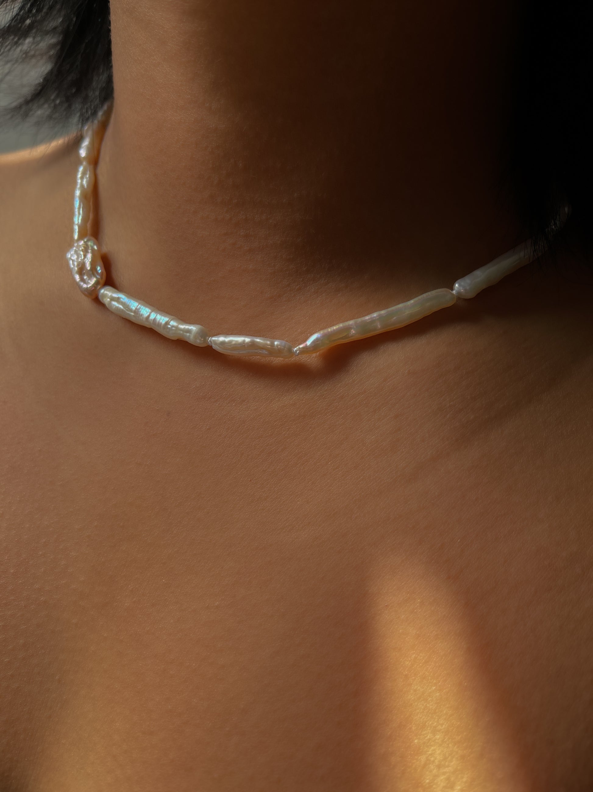 Luxe Keshi & Biwa Pearl Necklace. Biwa and Keshi pearls, naturally white with an iridescent shine and in free formed shapes feature on this stunning necklace. Elongated shaped Biwa pearls are peppered with nugget shaped Keshi pearls. This necklace is handcrafted using 100% Silk thread, and is highlighted with 14kt Gold Filled beads and hardware