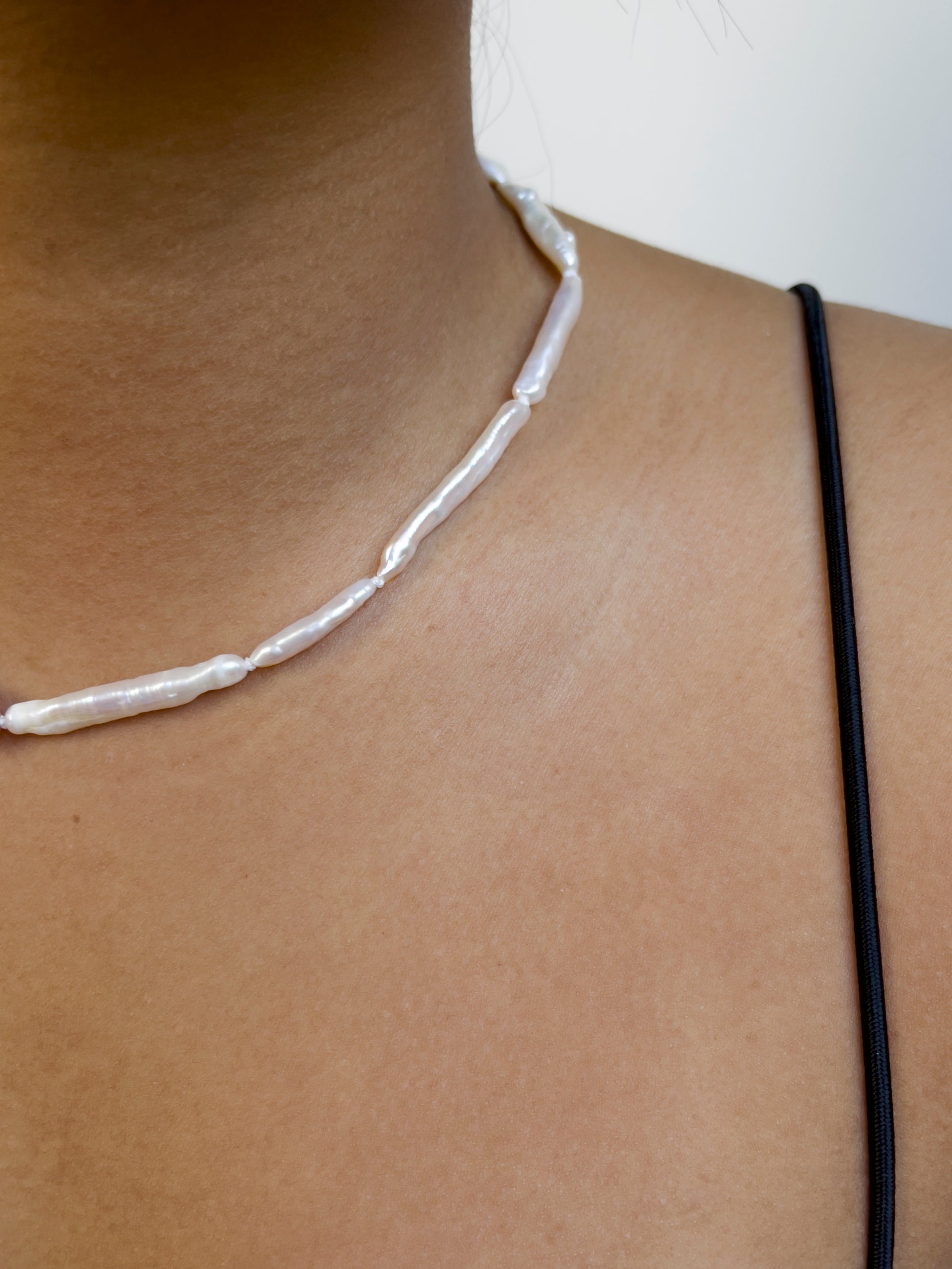 Luxe Keshi & Biwa Pearl Necklace. Biwa and Keshi pearls, naturally white with an iridescent shine and in free formed shapes feature on this stunning necklace. Elongated shaped Biwa pearls are peppered with nugget shaped Keshi pearls. This necklace is handcrafted using 100% Silk thread, and is highlighted with 14kt Gold Filled beads and hardware