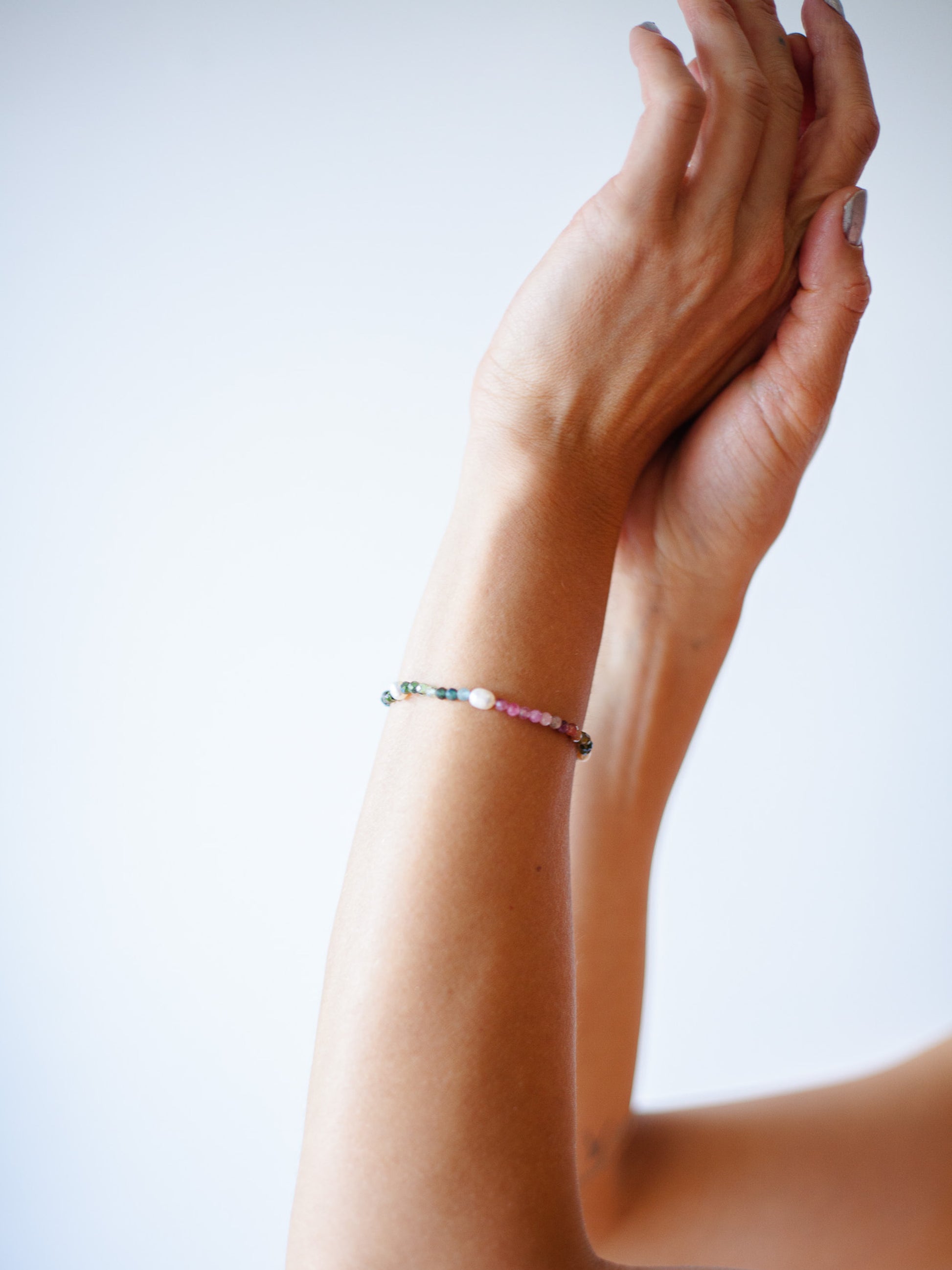 Nāmaka Tourmaline & Pearl Bracelet - Each tourmaline gem, with unique colours and patterns, sparkle and catch the eye. Teamed with a scattering of freshwater pearls highlight the piece.  This bracelet is both casual yet elegant, and can be teamed with matching earrings and necklace.  Designed & handcrafted by Nāmaka in Melbourne Australia