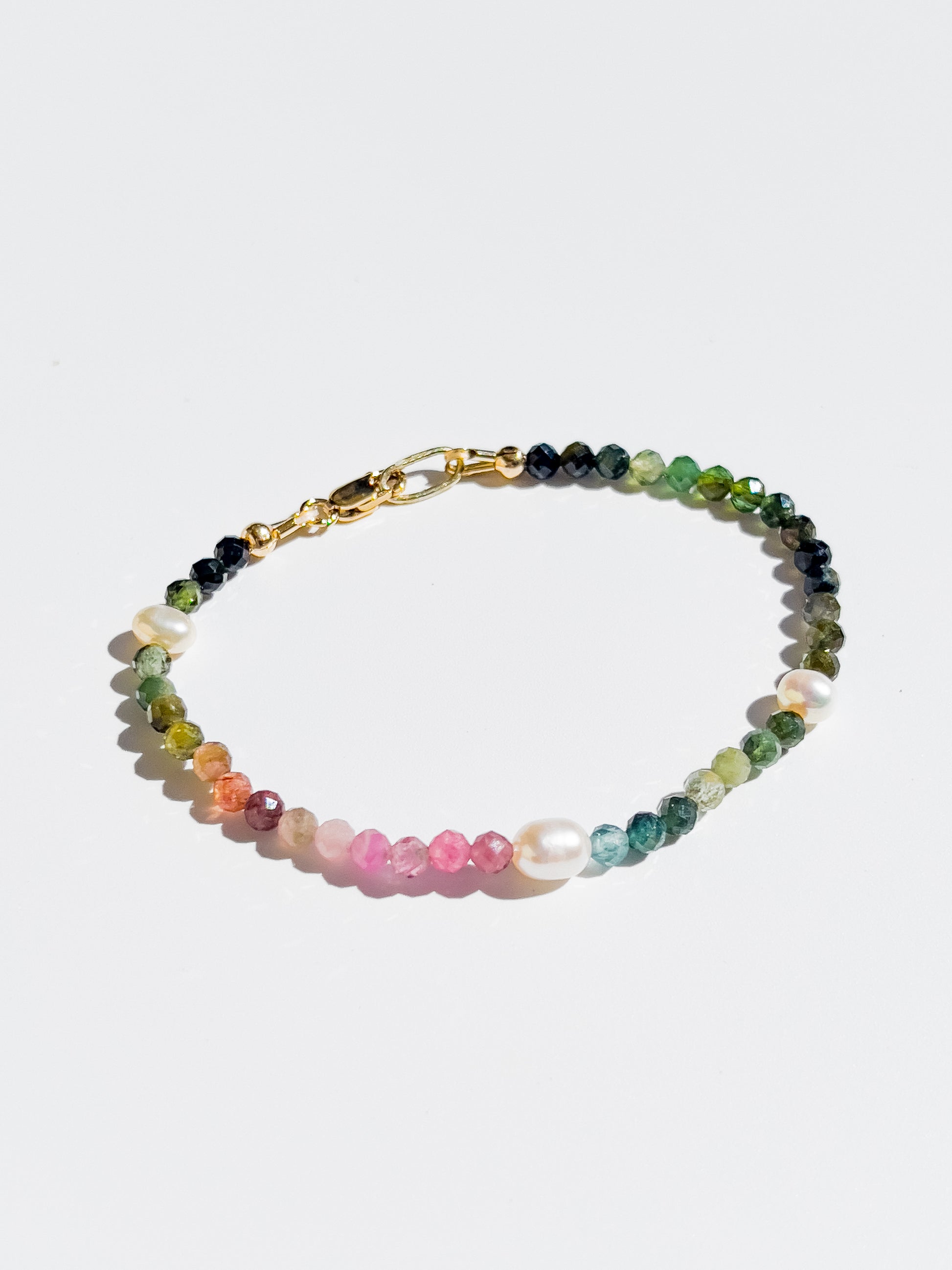 Nāmaka Tourmaline & Pearl Bracelet - Each tourmaline gem, with unique colours and patterns, sparkle and catch the eye. Teamed with a scattering of freshwater pearls highlight the piece.  This bracelet is both casual yet elegant, and can be teamed with matching earrings and necklace.  Designed & handcrafted by Nāmaka in Melbourne Australia