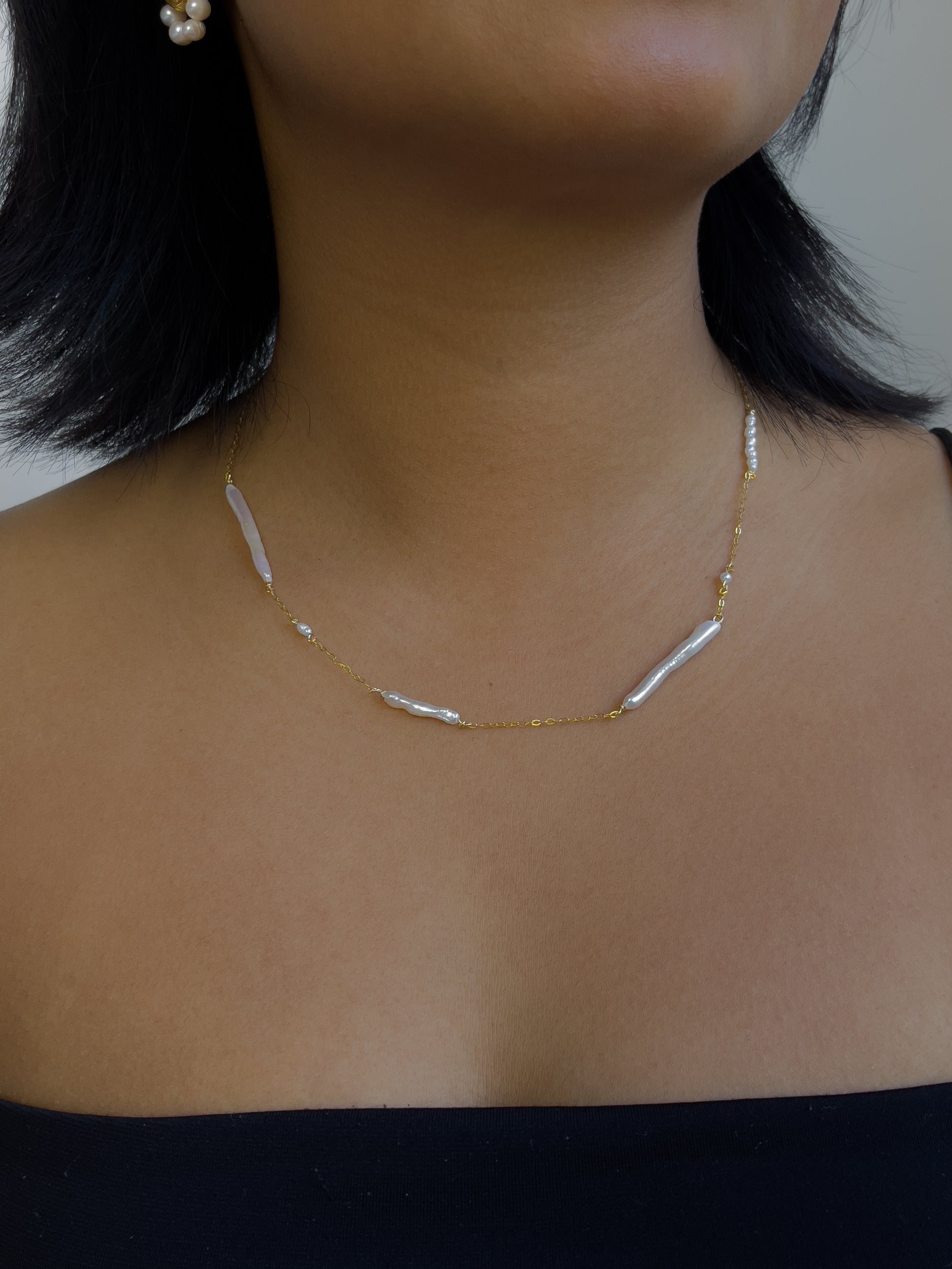 Biwa pearl gold necklace. This ultra fine 14 karat Gold filled with sterling silver flat cable chain suspends gorgeous Biwa elongated freshwater pearls and freshwater seed pearls. Designed and made by nāmaka.