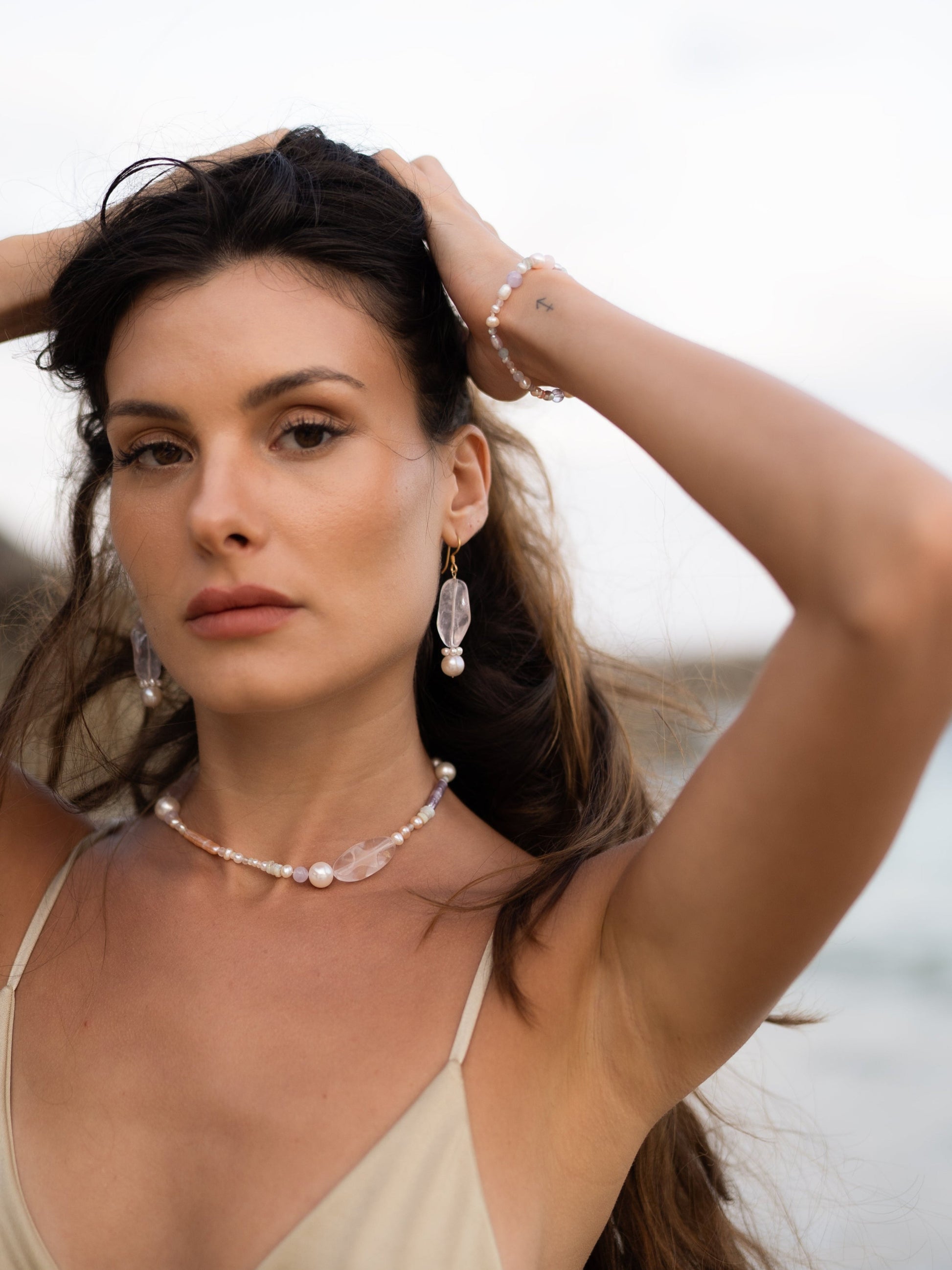 Woman with jewelry and a necklace outdoors