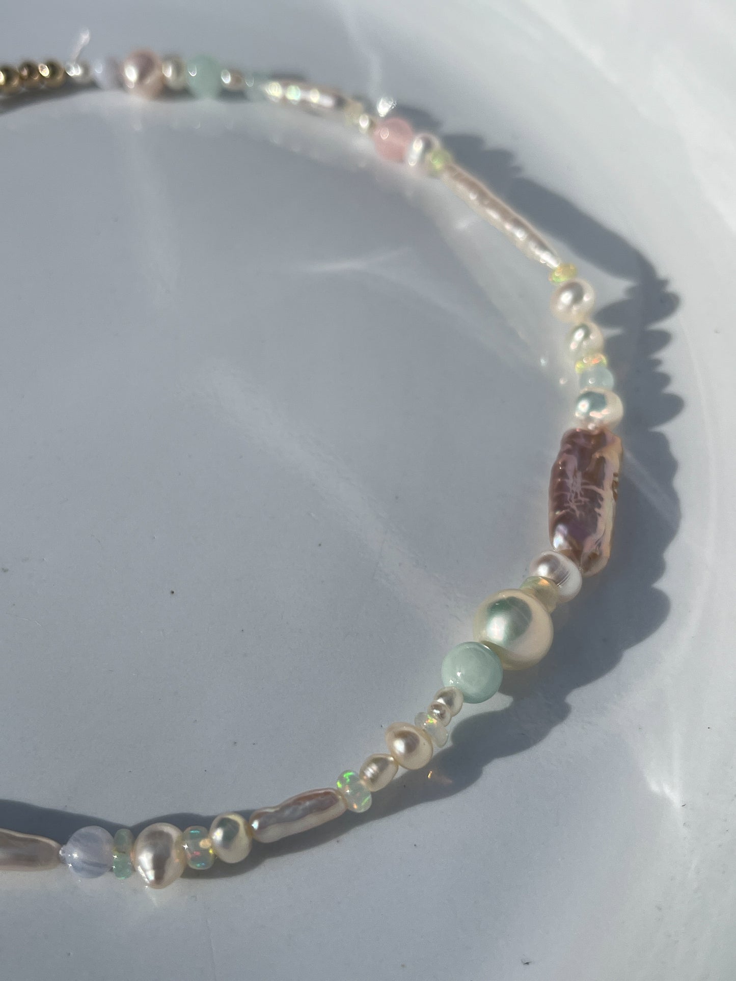 Candy Pearl & Multi-stone Necklace - Glistening in candy colours, and finished with 14 karat Gold hardware, this necklace is absolutely gorgeous. Hand crafted with a variety of Violet Keshi Pearls, South Sea Pearls, Biwa Pearls, Freshwater Pearls & Pink Freshwater Pearls. Combined with a glittery cluster of Australian Opals, Aquamarine, Blue Lace Agate, Jade, and the ultimate - The Super Seven Stone. Designed and made by nāmaka