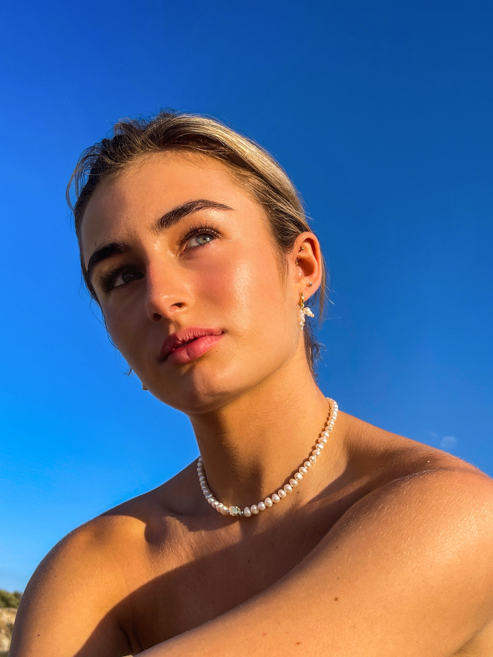 Mini Confetti Opal & Pearl Gold Hoops. Tiny 14 karat Gold filled Sterling Silver sleeper hoops, suspend clusters of natural freshwater pearls, and Australian Opals, in a minimal asymmetrical design.