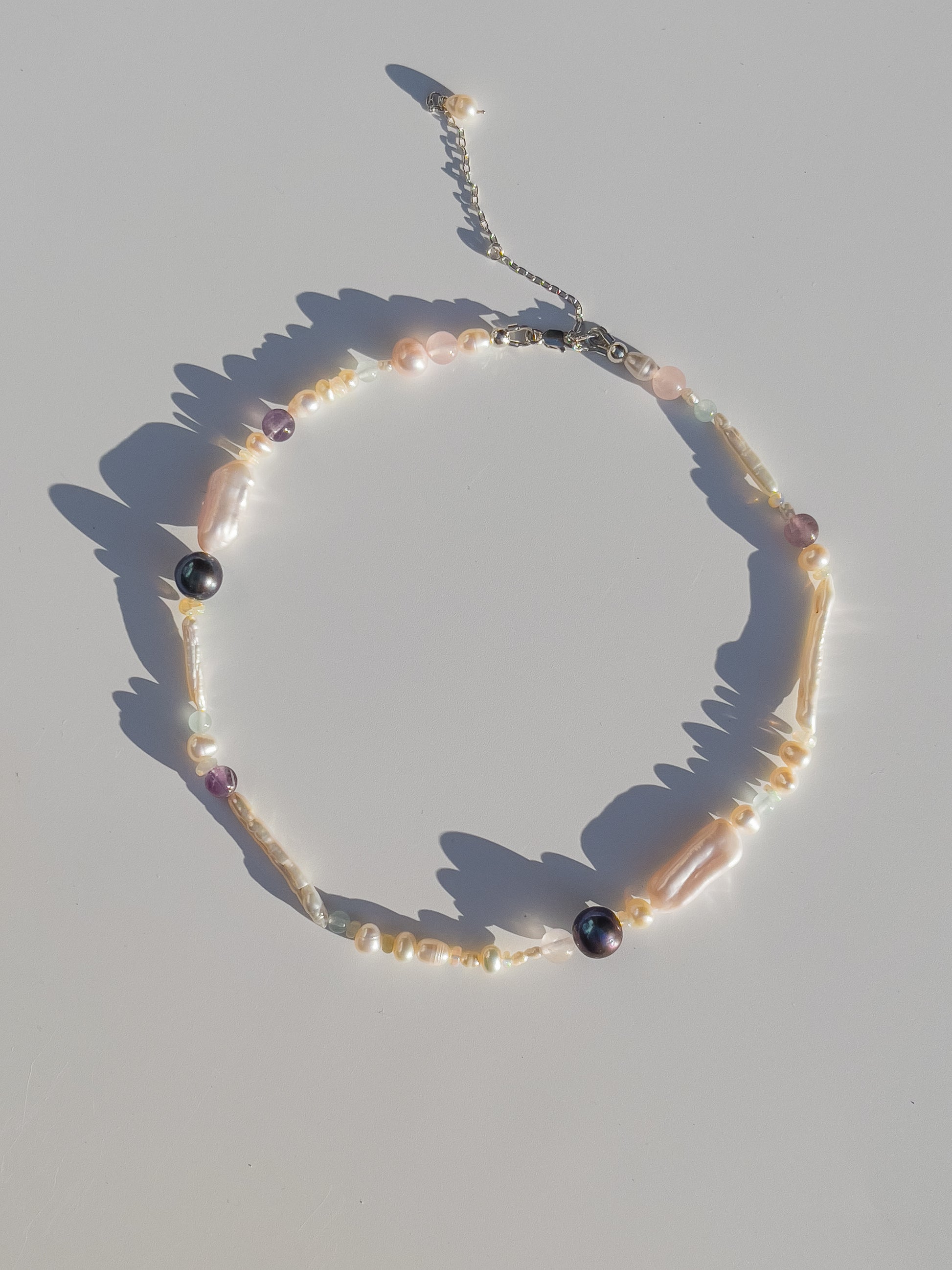 Tahitian Black Pearl & Opal Multi-Stone Choker Necklace - Glistening in candy colours, and finished with Sterling Silver hardware, this necklace is absolutely gorgeous. Hand crafted with a variety of Vibrant White Keshi Pearls, Estate re-purposed Tahitian Black Pearls, Biwa Pearls, Freshwater Pearls & Pink Freshwater Pearls. Combined with a glittery cluster of Australian Opals, Aquamarine, Blue Lace Agate, Jade, and the ultimate - The Super Seven Stone.  Designed and personally handcrafted by Nāmaka