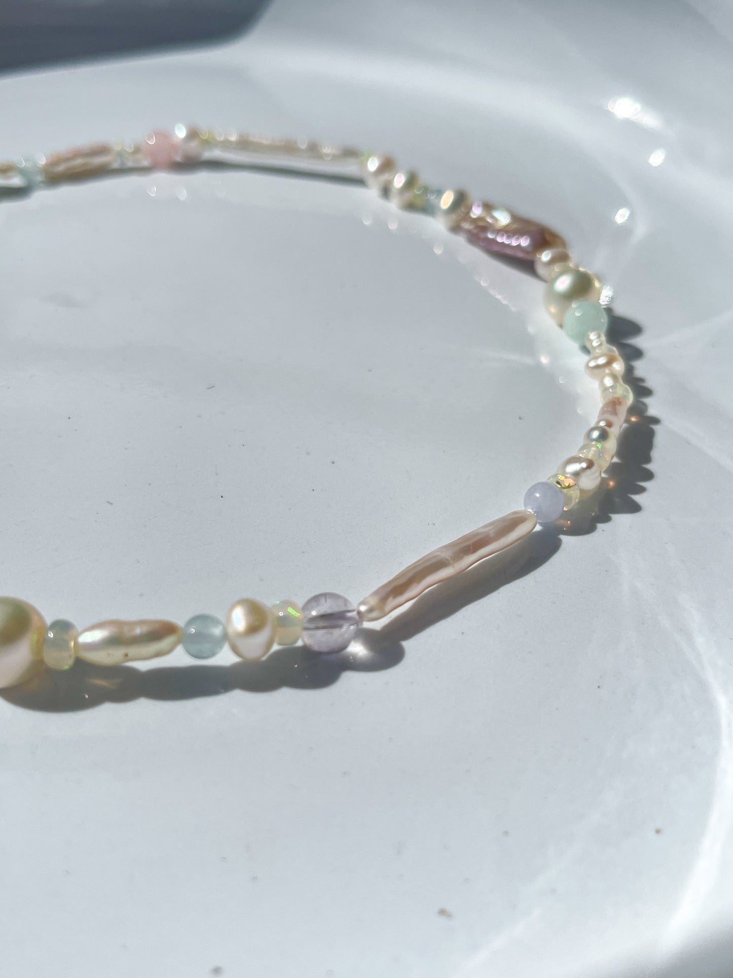 Candy Pearl & Multi-stone Necklace - Glistening in candy colours, and finished with 14 karat Gold hardware, this necklace is absolutely gorgeous. Hand crafted with a variety of Violet Keshi Pearls, South Sea Pearls, Biwa Pearls, Freshwater Pearls & Pink Freshwater Pearls. Combined with a glittery cluster of Australian Opals, Aquamarine, Blue Lace Agate, Jade, and the ultimate - The Super Seven Stone. Designed and made by nāmaka