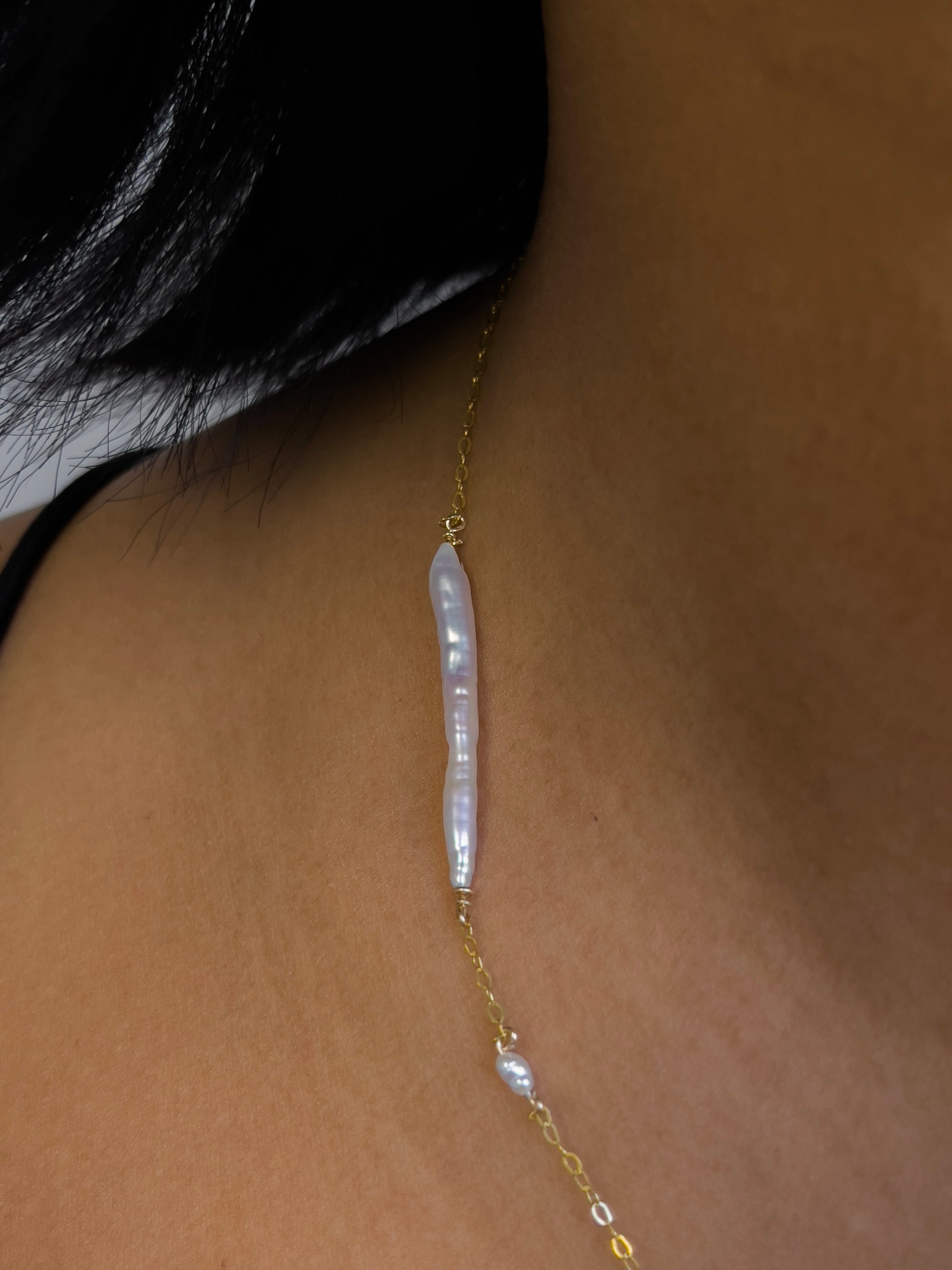 Biwa pearl gold necklace. This ultra fine 14 karat Gold filled with sterling silver flat cable chain suspends gorgeous Biwa elongated freshwater pearls and freshwater seed pearls. Designed and made by nāmaka.