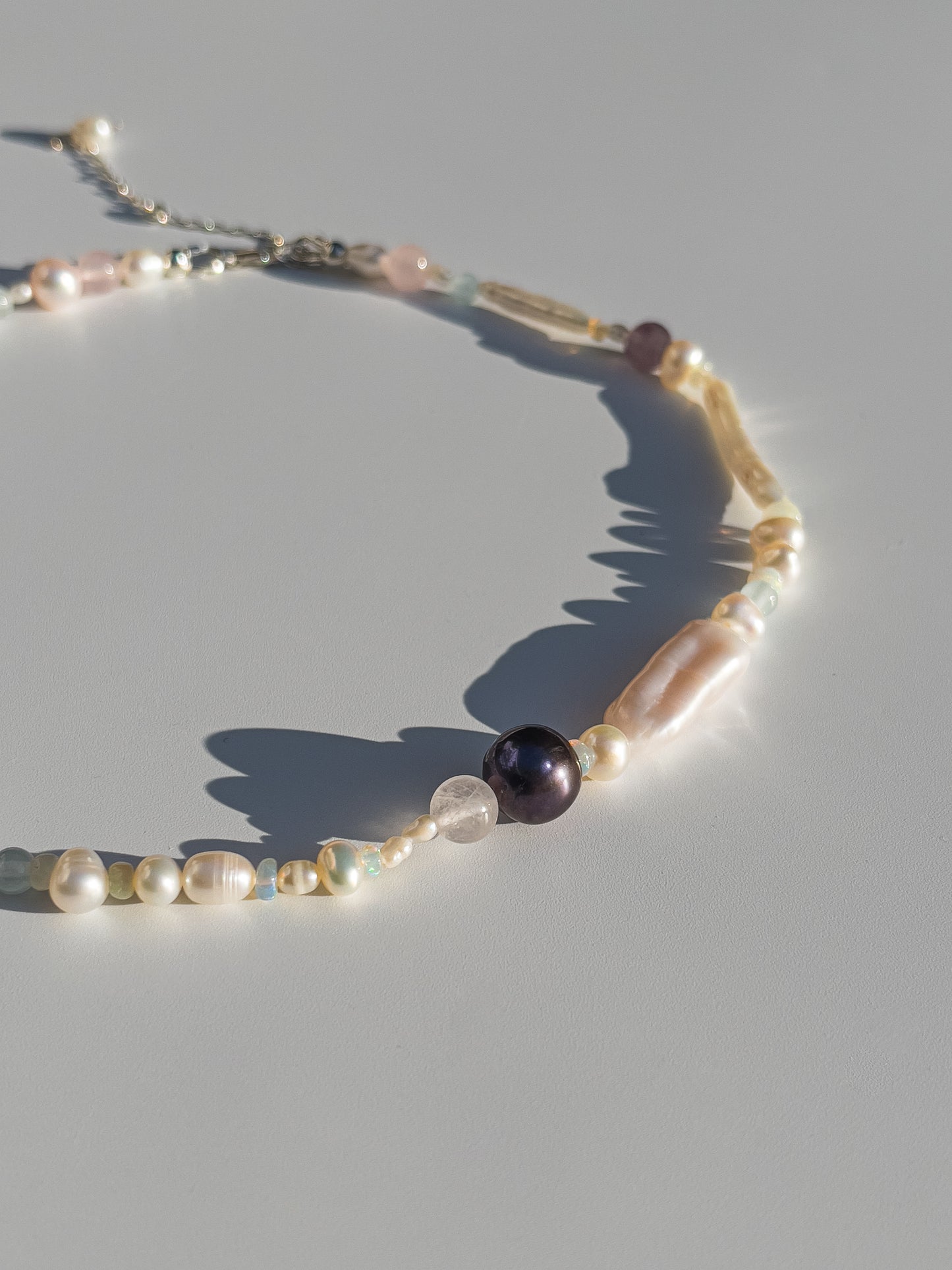 Tahitian Black Pearl & Opal Multi-Stone Choker Necklace - Glistening in candy colours, and finished with Sterling Silver hardware, this necklace is absolutely gorgeous. Hand crafted with a variety of Vibrant White Keshi Pearls, Estate re-purposed Tahitian Black Pearls, Biwa Pearls, Freshwater Pearls & Pink Freshwater Pearls. Combined with a glittery cluster of Australian Opals, Aquamarine, Blue Lace Agate, Jade, and the ultimate - The Super Seven Stone.  Designed and personally handcrafted by Nāmaka