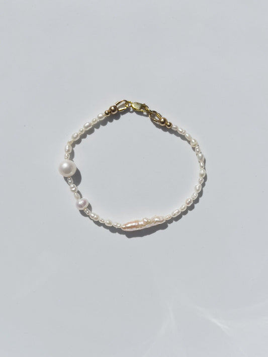 Biwa Pearl Bracelet. Natural elongated Biwa pearls placed off centre with a bold spherical Freshwater pearls. Using natural AAA quality freshwater pearls, in a minimal asymmetrical design. 14 Karat Gold filled Sterling Silver hardware finishes the piece. Designed and made by nāmaka