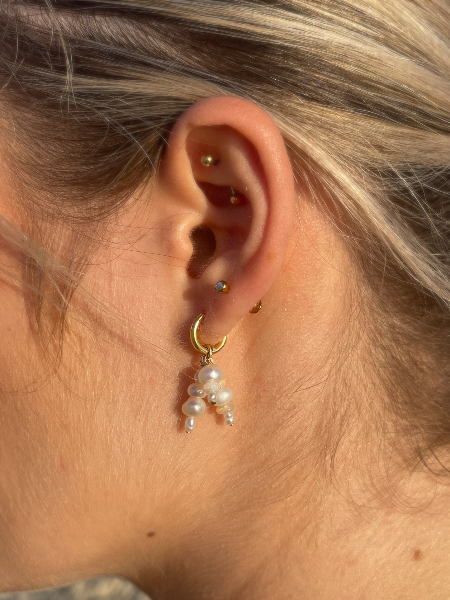 Mini Confetti Opal & Pearl Gold Hoops. Tiny 14 karat Gold filled Sterling Silver sleeper hoops, suspend clusters of natural freshwater pearls, and Australian Opals, in a minimal asymmetrical design.